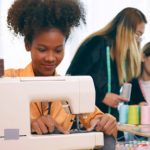 A group of young women are learning the profession of design and tailoring.